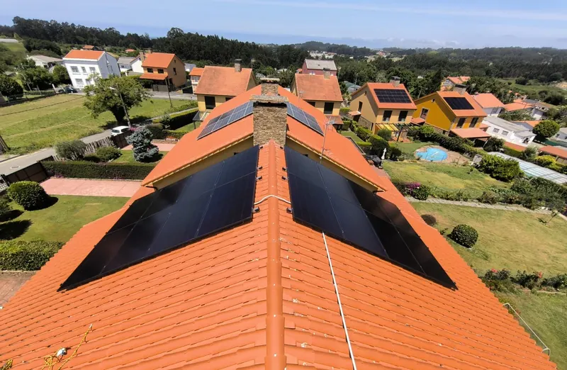 Vista aérea de varias viviendas con paneles solares en el tejado