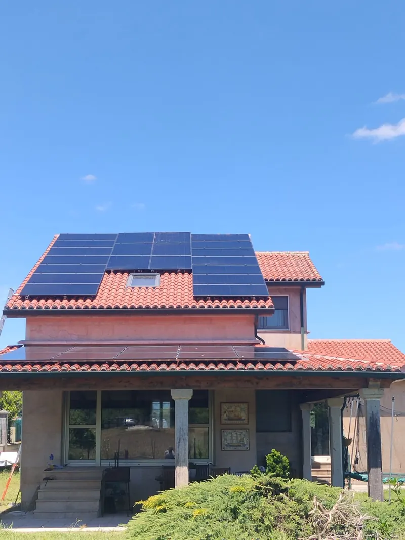 Vivienda con placas solares en el tejado y en el porche